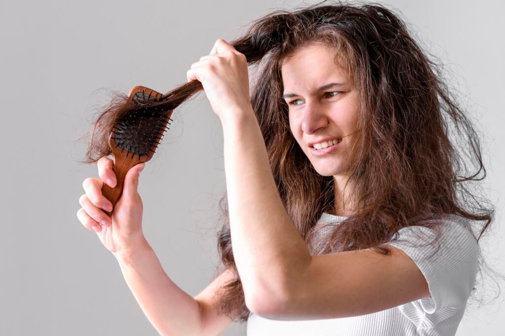 Frizzy Hair in Winter : Causes and Remedies female struggling brush hair